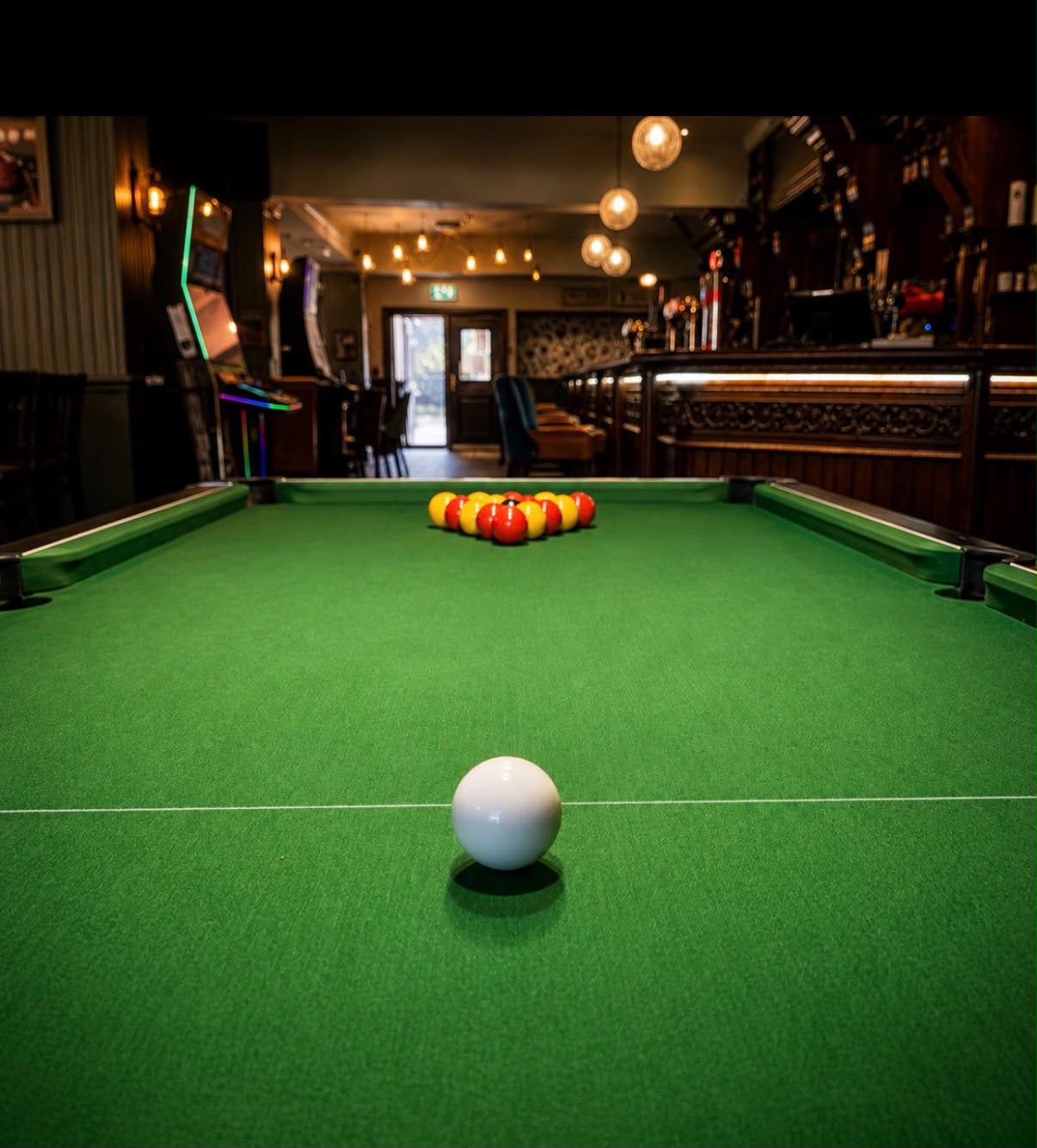 Pool table with balls racked and cue ball ready at a Thatcham pub